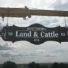 "Southern Land and Cattle Co." metal sign